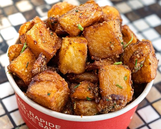 Amir food photography showing grilled chicken pieces.